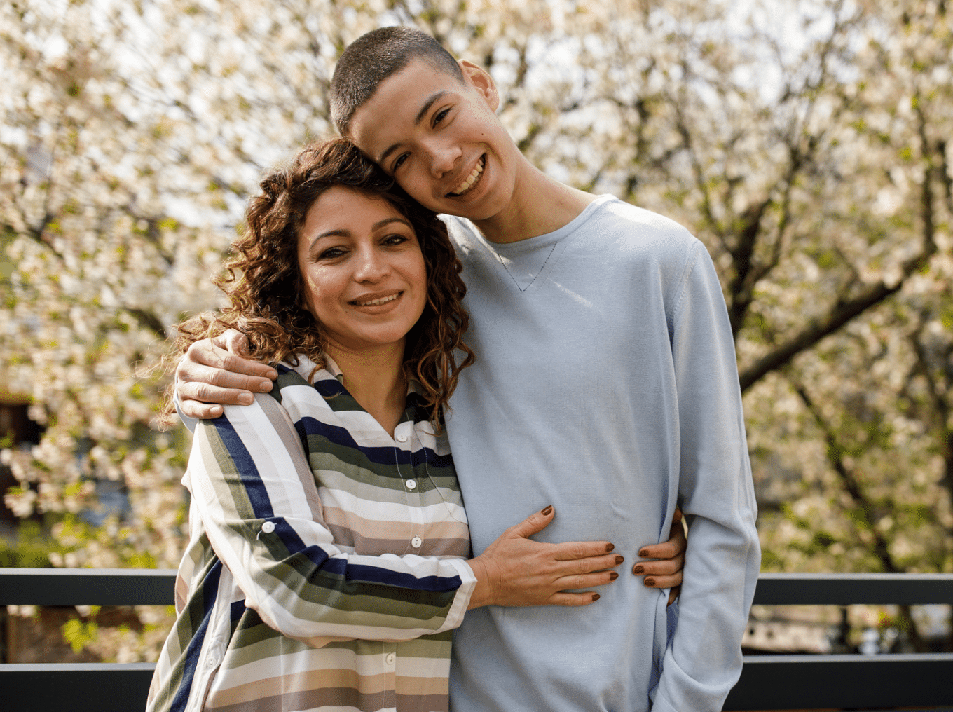 Mother and son smiling outdoors